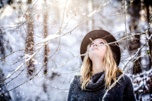 Young woman with blond hair dressed wintry, looking upwards Young woman with blond hair dressed wintry, looking upwards